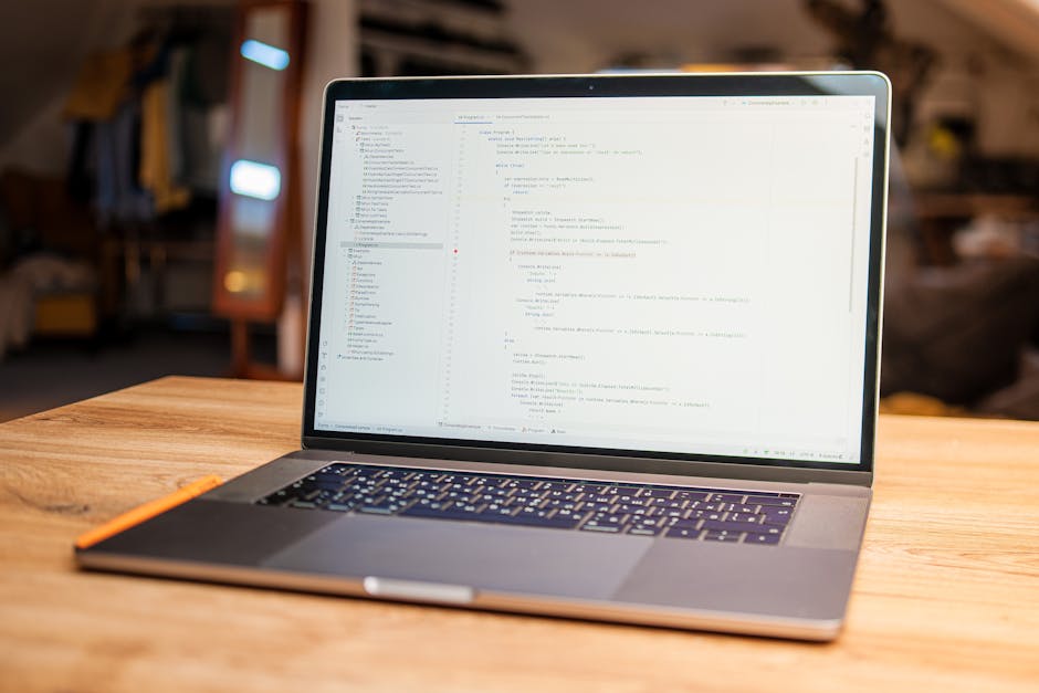 A close-up image of a laptop screen displaying lines of green, blue, and white code on a dark background, positioned next to a coffee mug with the phrase 'This coffee is making me awesome' printed on 